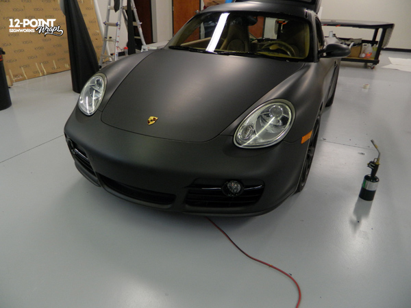 Matte black vinyl wrap on a Porsche Cayman. 12-Point SignWorks