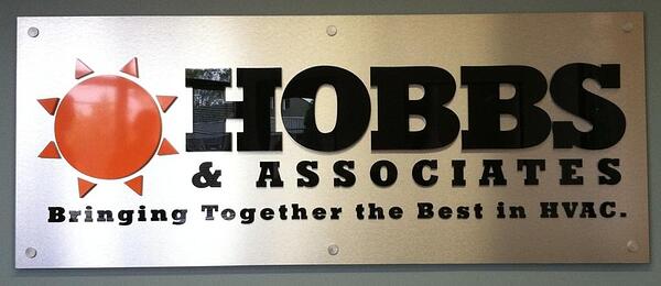 Acrylic letters and logo on brushed metal sign panel
