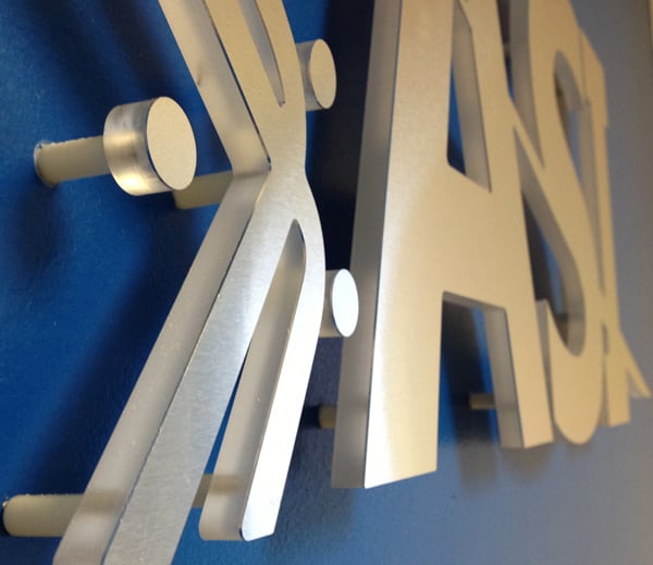 Studs and spacers used to fasten the ASI logo sign. 12-Point SignWorks