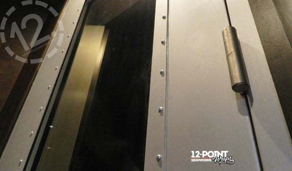 Close-up of the detail on the doors at Black River at Sound Stage. 12-Point SignWorks