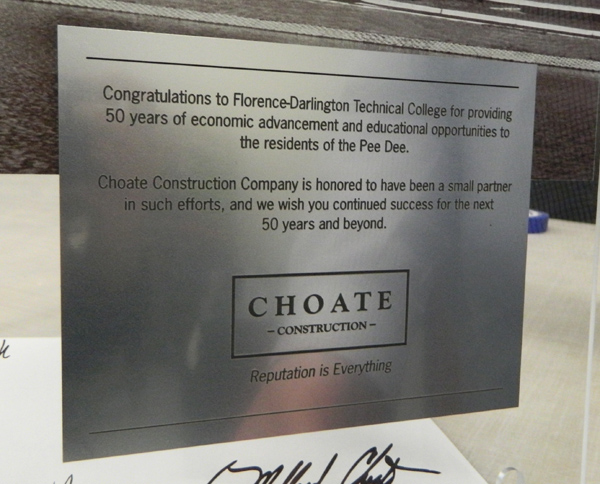 A close-up view of the rowmark laser etched plaque that we adhered to the acrylic display for Choate Construction. 12-Point SignWorks