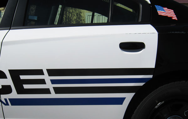 A damaged door on a City of Franklin Police Department cruiser. 12-Point SignWorks