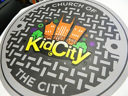A photo of the manhole floor graphic for Church of the City in Franklin, TN. 12-Point SignWorks