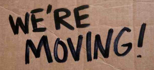 We're Moving sign written on a plain cardboard box. 12-Point SignWorks