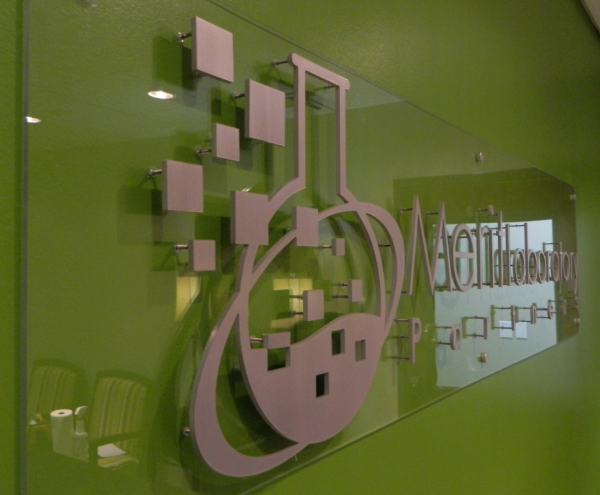 interior brushed metal logo sign on acrylic panel
