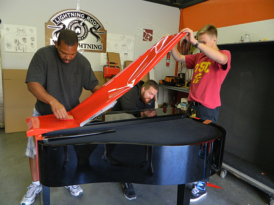 Our installation team wrapping the piano for Kelly Clarkson