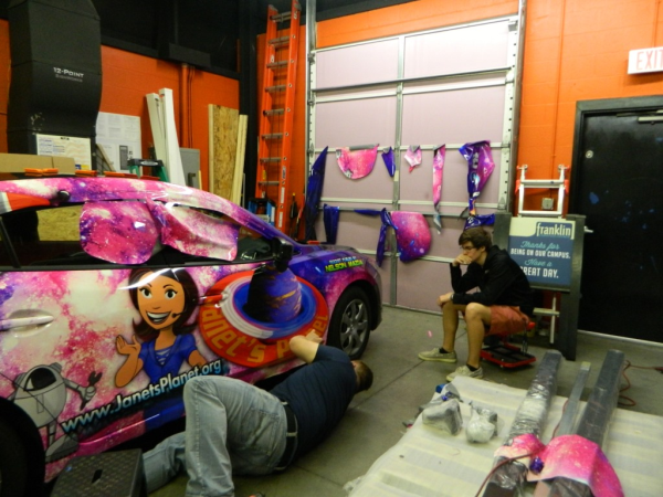 Rich wrapping the car while Jordan, Murray&squot;s son, "supervises." 12-Point SignWorks