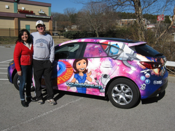 Janet and her husband next to their completed car wrap! 12-Point SignWorks