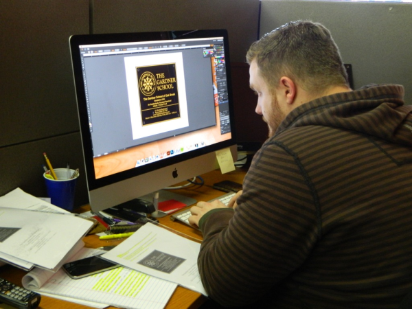 Rich designing a bronze plaque for a local school. 12-Point SignWorks