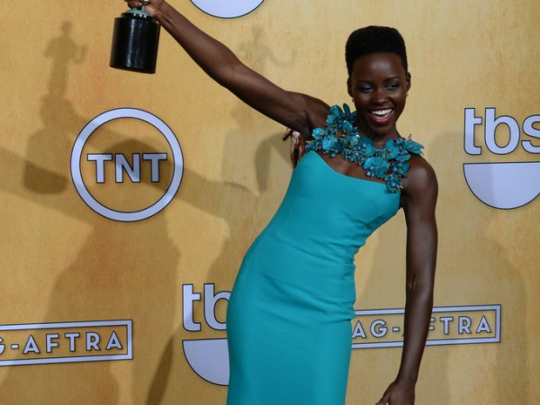 Lupita Nyong'o at the Screen Actor's Guild Awards in front of a step and repeat backdrop