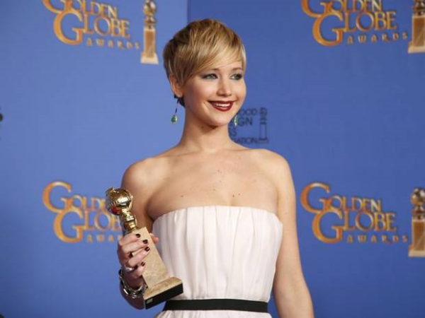 Jennifer Lawrence at the Golden Globes in front of a step and repeat backdrop