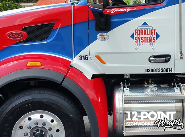 Logo graphics and personlized name graphics on the cab of the Forklift Systems' Peterbilt rollback truck. 12-Point SignWorks - Franklin, TN