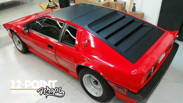 Partial matte black wrap to the roof, deck lid, window louvres and window posts of a 1984 Lotus Esprit.
