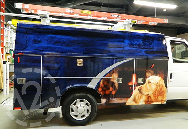 Wrap installation in progress for the Sweep and Ladders Ford E350. 12-Point SignWorks - Franklin TN
