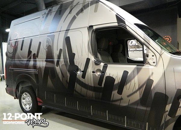 The Nissan NV2500 parts van with its first layer of custom vinyl. 12-Point SignWorks