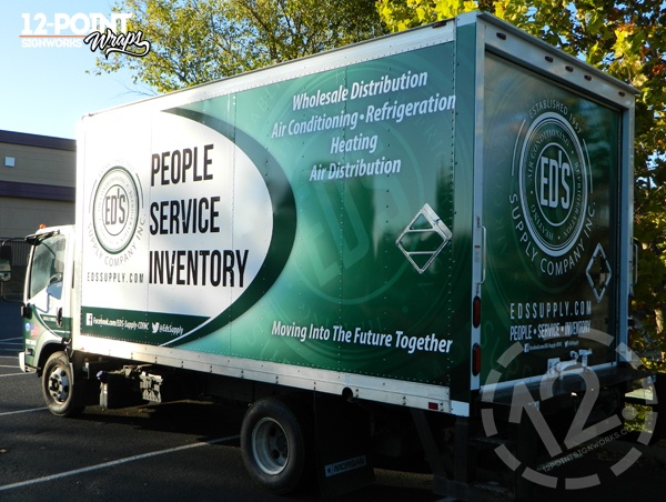 A view of the 16' box truck showing the design on the sides and back. 12-Point SignWorks