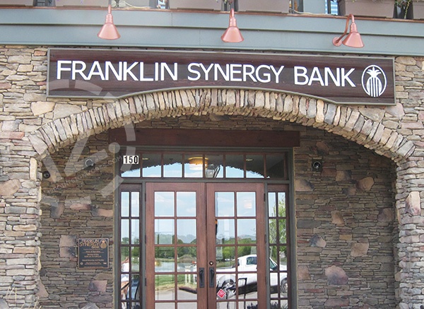 Custom sandblasted redwood logo sign for Franklin Synergy Bank in Westhaven. 12-Point SignWorks
