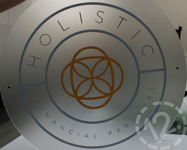 The assembled logo sign held up in our shop, showing the frosted acrylic backer. 12-Point SignWorks