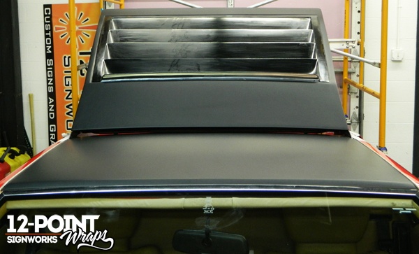 A photo of the roof and deck lid wrapped in matte deep black vinyl. 12-Point SignWorks