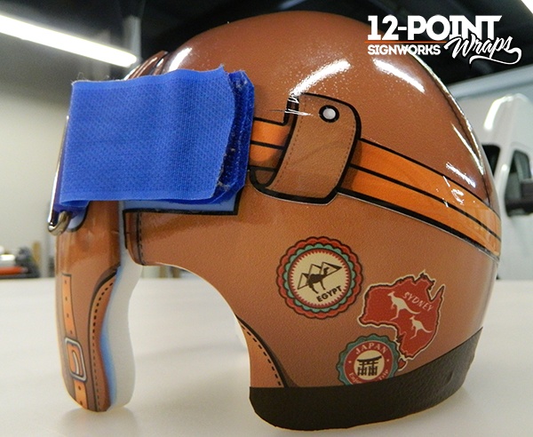 An aviator wrap on a cranial orthotic helmet. 12-Point SignWorks