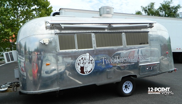 Graphics for Two Thompsons Catering installed on their Airstream trailer. 12-Point SignWorks