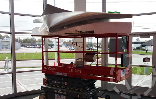 The plane on its foam cradle and the scissor lift. 12-Point SignWorks