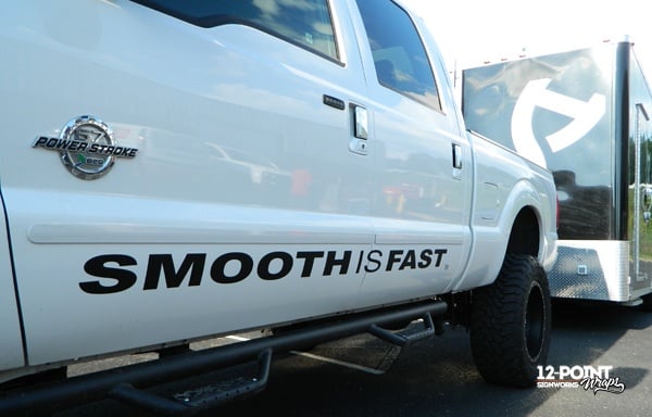 Cut vinyl lettering on the side of the SMOOTHISFAST Ford F-350. 12-Point SignWorks