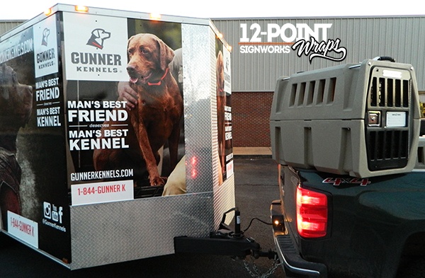 A view of the trailer with a dog crate on the bed of the truck. 12-Point SignWorks
