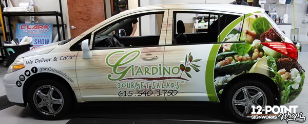 The Nissan Versa for Giardino Gourmet Salads with the full advertising wrap installed by 12-Point SignWorks in Franklin, TN.